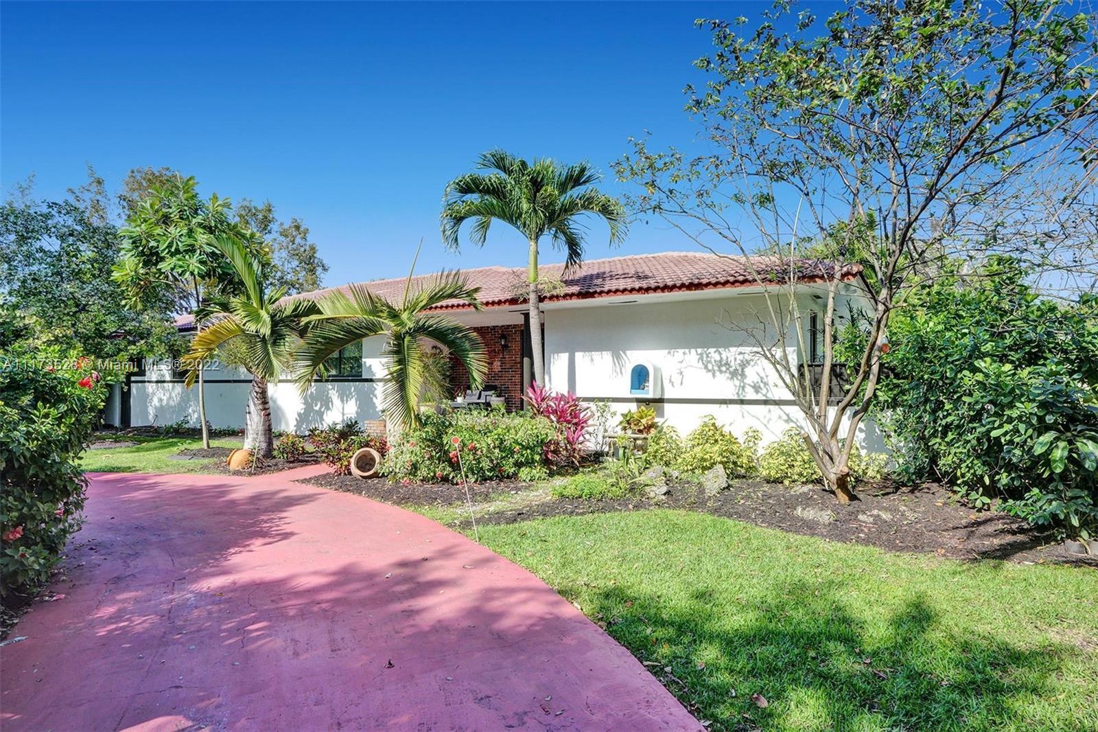 10801 Griffing Boulevard Biscayne Park, FL 33161 - Photo 75 of 77 a front view of a house with a yard