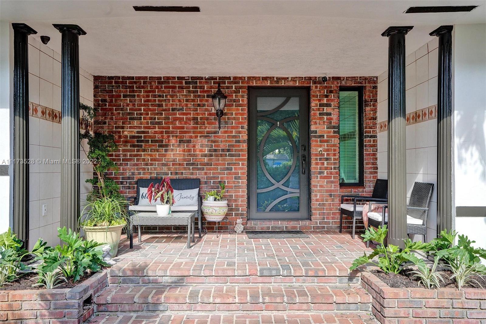 10801 Griffing Boulevard Biscayne Park, FL 33161 - Photo 76 of 77 a building with potted plants in front of it