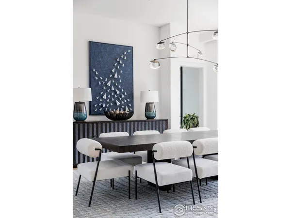 a view of a room with a table and chairs