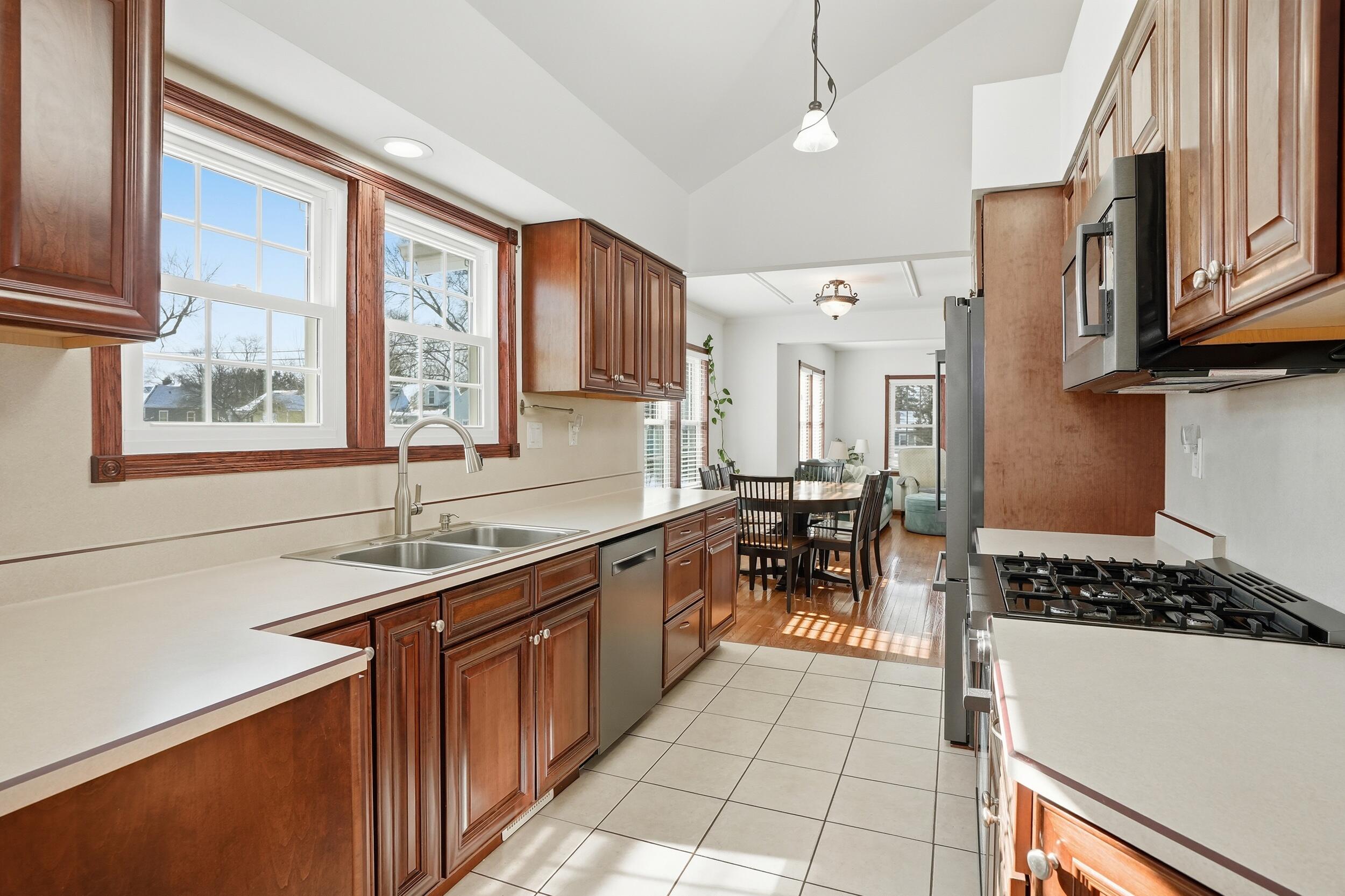 228 Wood Street Crown Point, IN 46307 - Photo 16 of 33 a kitchen with stainless steel appliances granite countertop a sink stove and cabinets