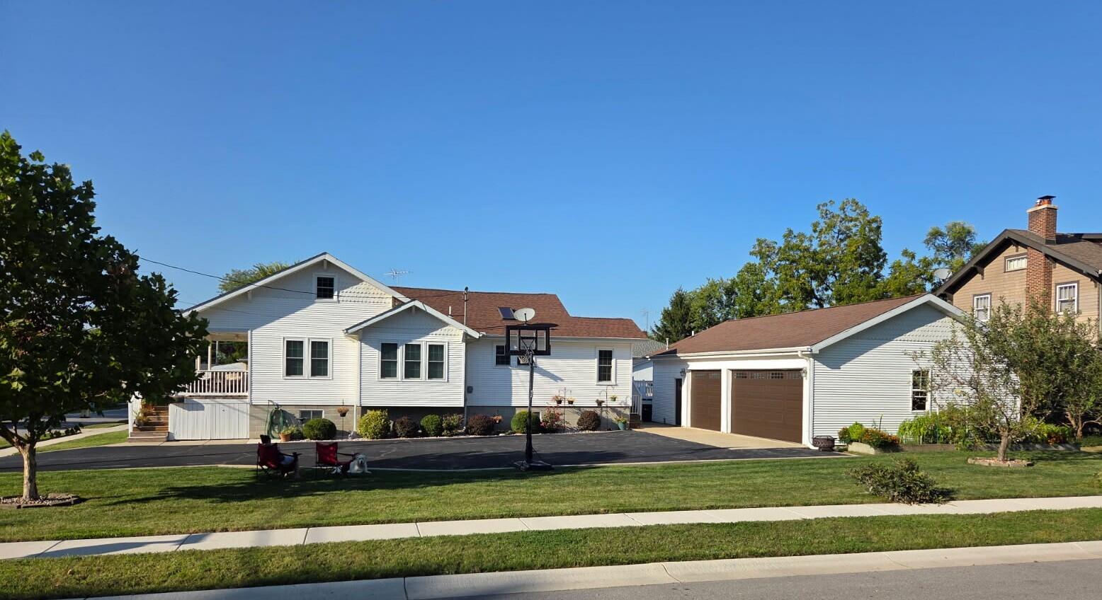 228 Wood Street Crown Point, IN 46307 - Photo 5 of 33 a front view of a house with a garden