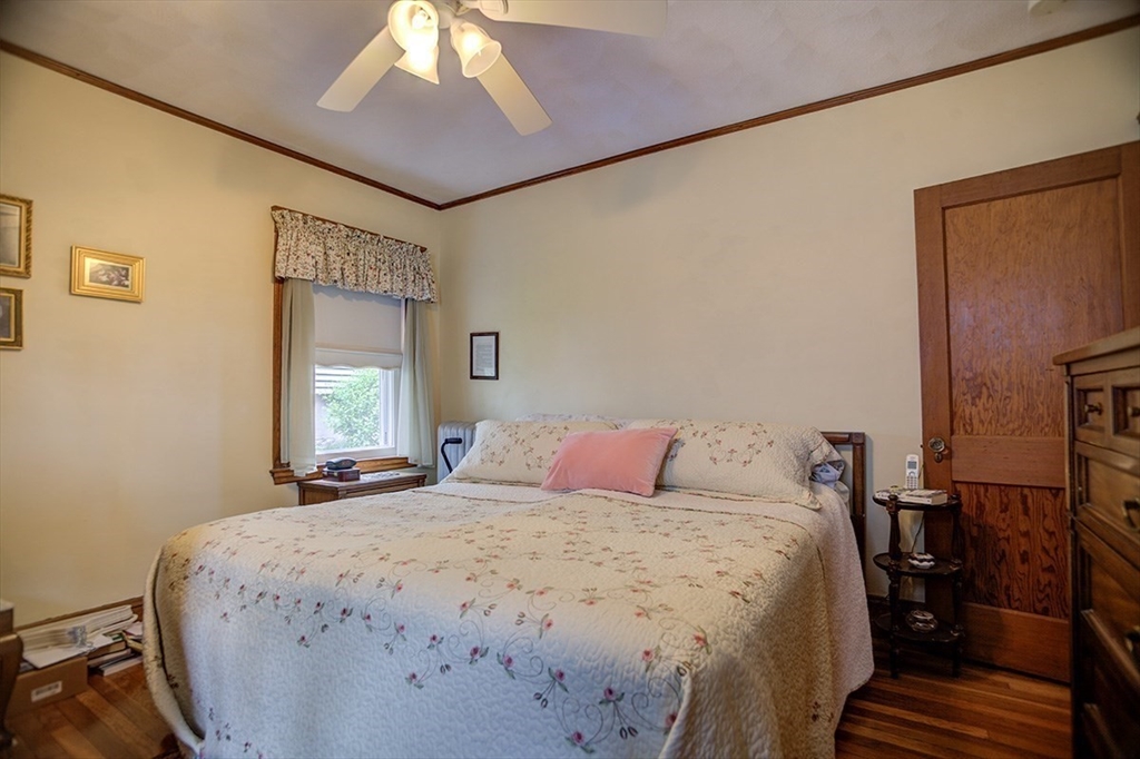 44 Cottage Park Road Winthrop, MA 02152 - Photo 32 of 39 a bedroom with a bed and a chandelier