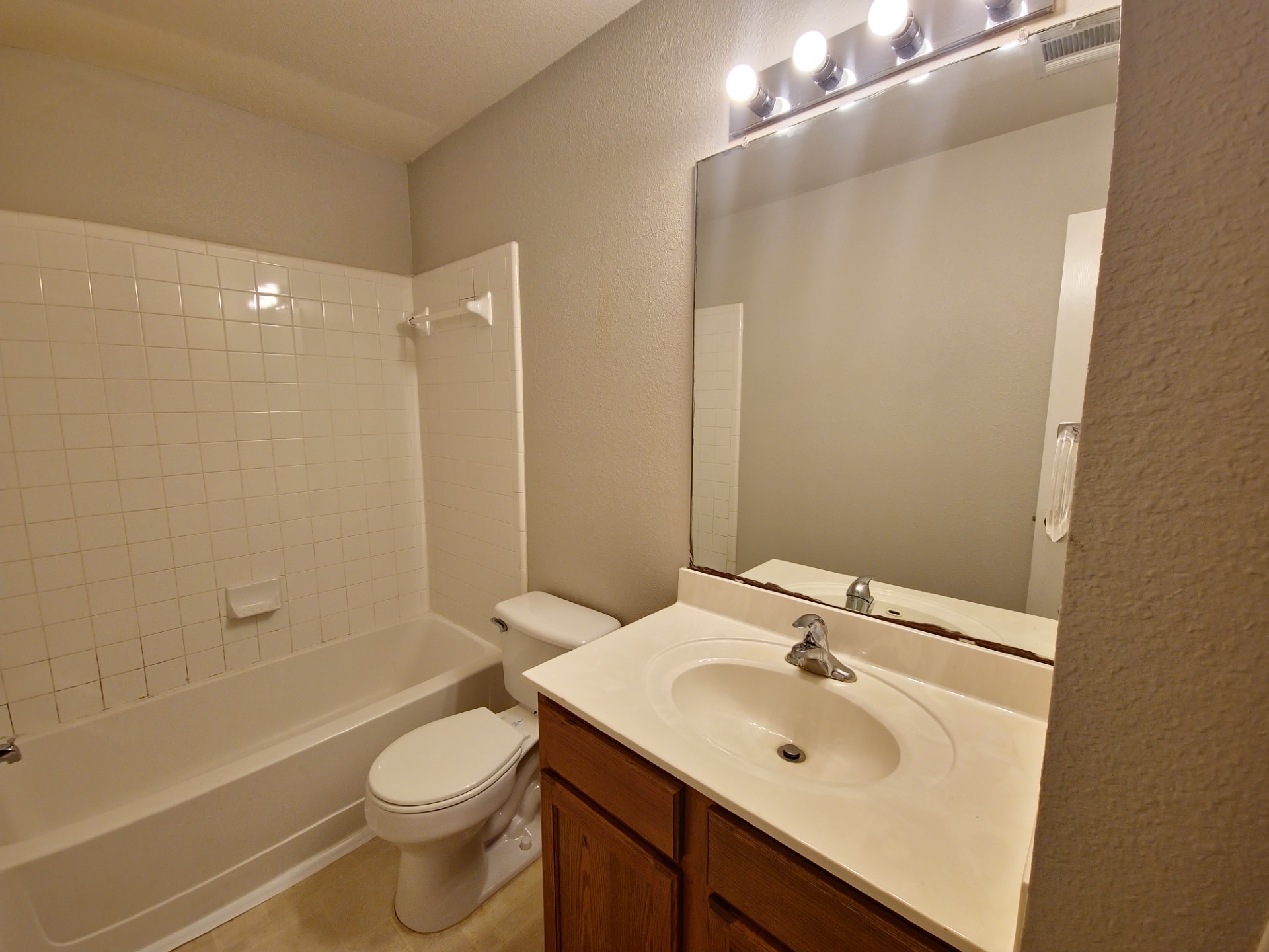 107 Orange Tree Lane Georgetown, TX 78626 - Photo 14 of 16 Functional full bathroom with a spacious bathtub and a wide vanity mirror.