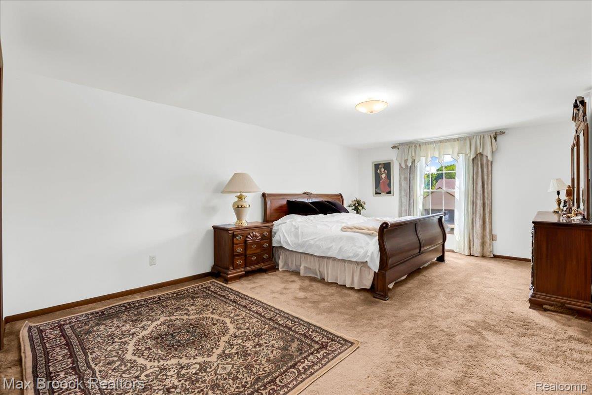 217 Stonetree Circle Rochester, MI 48309 - Photo 36 of 44 Expansive room with neutral carpeting and white walls