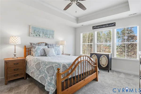 a bedroom with a bed a baby crib and a window