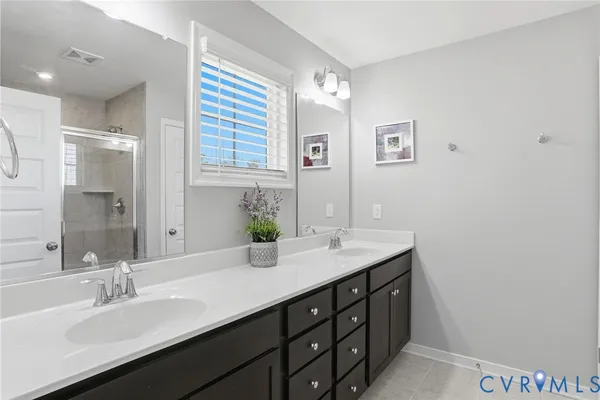 a bathroom with a double vanity sink and a mirror
