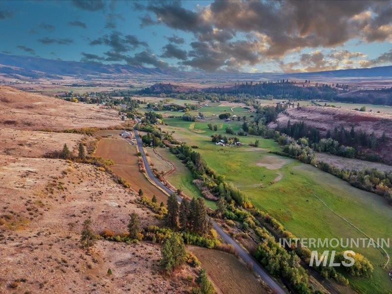 2651 Fruitvale Glendale Road Council, ID 83612 - Photo 23 of 24 Expansive valley landscape showcasing diverse terrain with rolling hills, cultivated fields, scattered residential structures, and a winding paved road