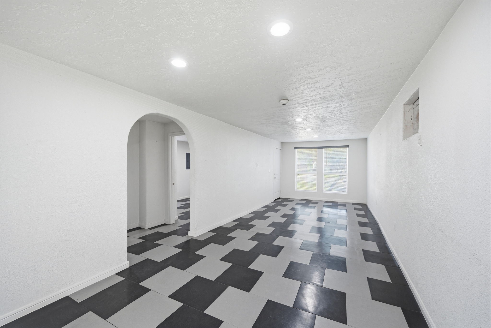 1041 Dolly Wright Street Houston, TX 77088 - Photo 3 of 12 an empty room with black and white checkered floor