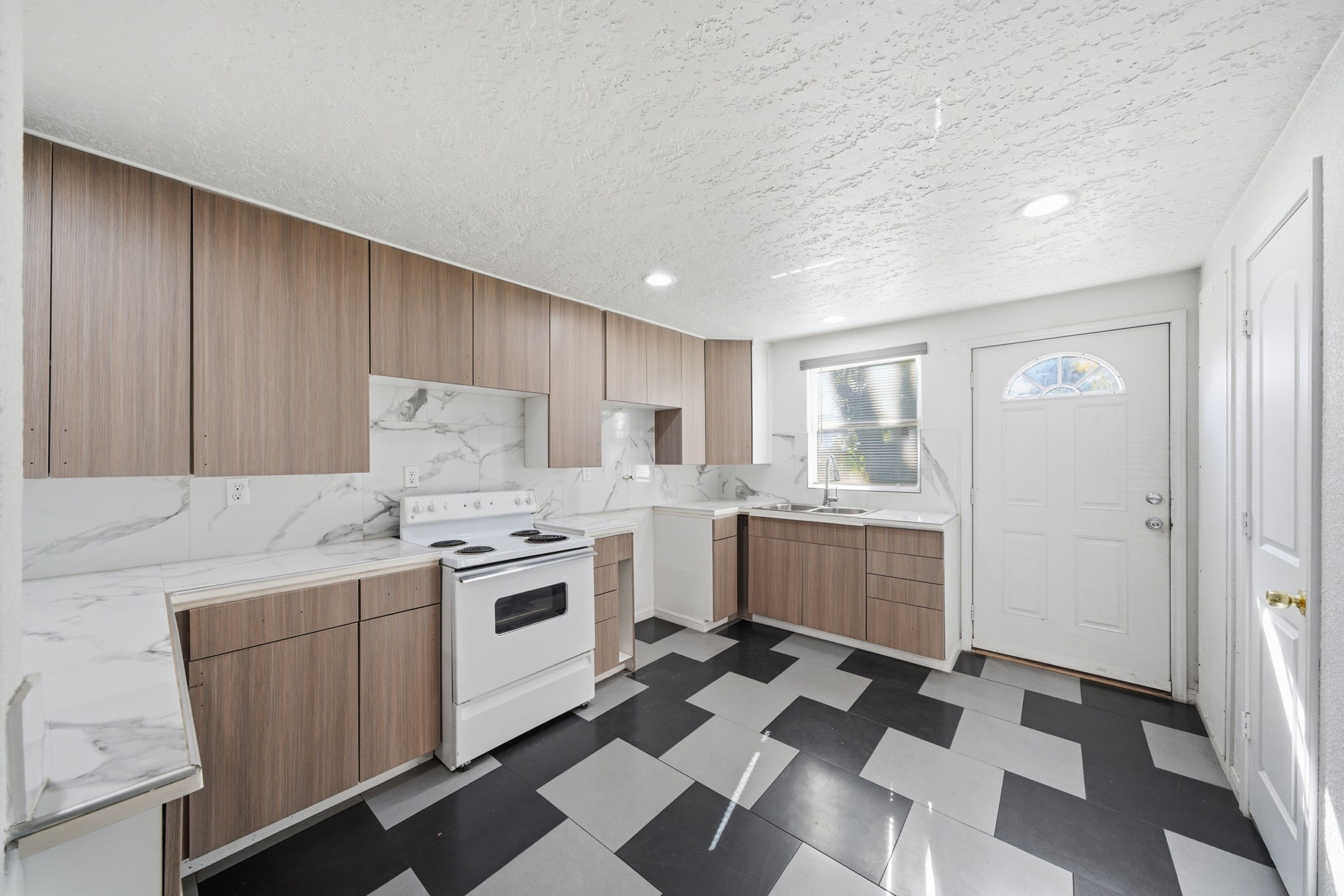 1041 Dolly Wright Street Houston, TX 77088 - Photo 5 of 12 a kitchen with a stove a sink and a refrigerator