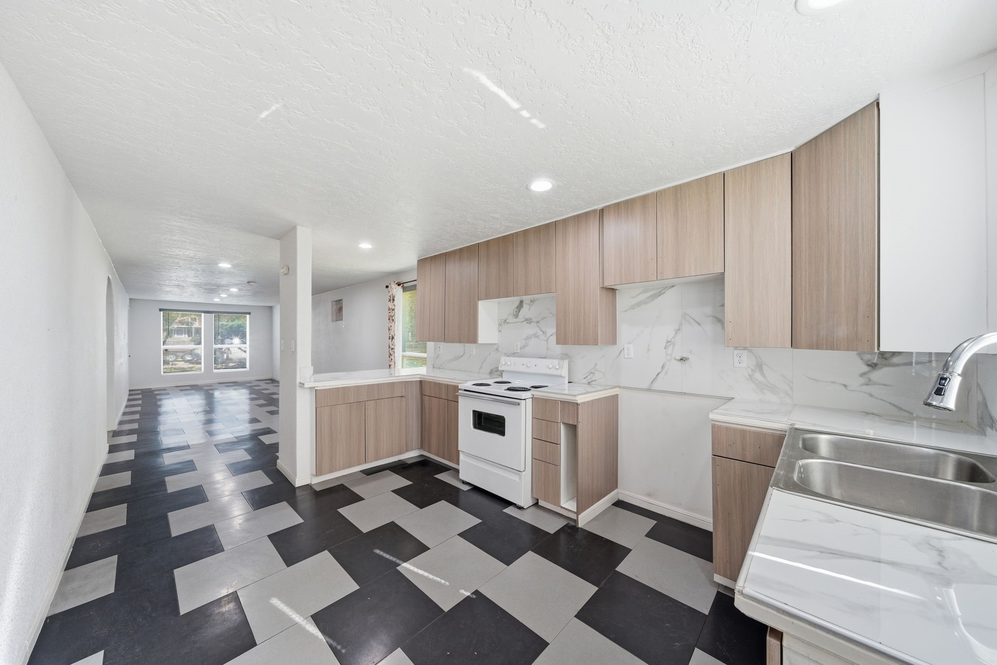 1041 Dolly Wright Street Houston, TX 77088 - Photo 6 of 12 a kitchen with granite countertop stainless steel appliances a sink and counter space