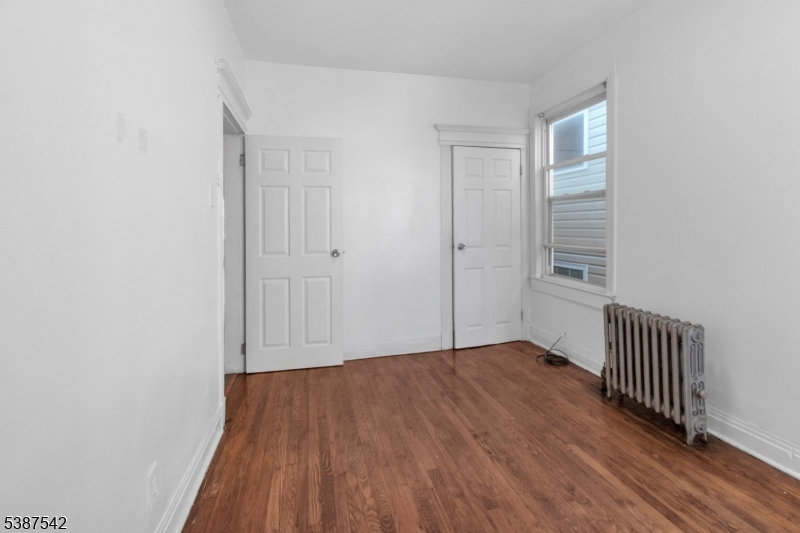 19 North 7th Street, Unit 2 Newark, NJ 07107 - Photo 13 of 21 an empty room with wooden floor and windows