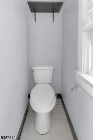 a white toilet sitting next to a white sink