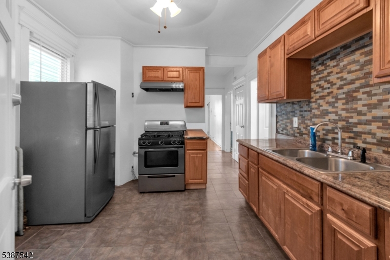 19 North 7th Street, Unit 2 Newark, NJ 07107 - Photo 3 of 21 a kitchen with stainless steel appliances granite countertop a refrigerator stove and sink