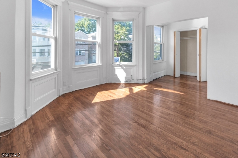 19 North 7th Street, Unit 2 Newark, NJ 07107 - Photo 7 of 21 a view of empty room with wooden floor and fan