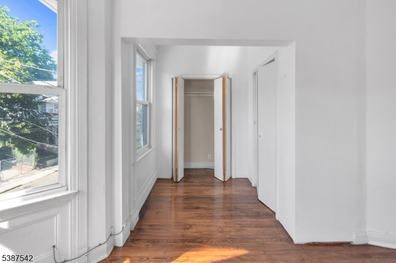 19 North 7th Street, Unit 2 Newark, NJ 07107 - Photo 8 of 21 a view of a hallway with wooden floor and windows
