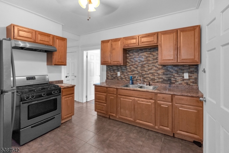 19 North 7th Street, Unit 2 Newark, NJ 07107 - Photo 9 of 21 a kitchen with stainless steel appliances granite countertop a stove sink and cabinets