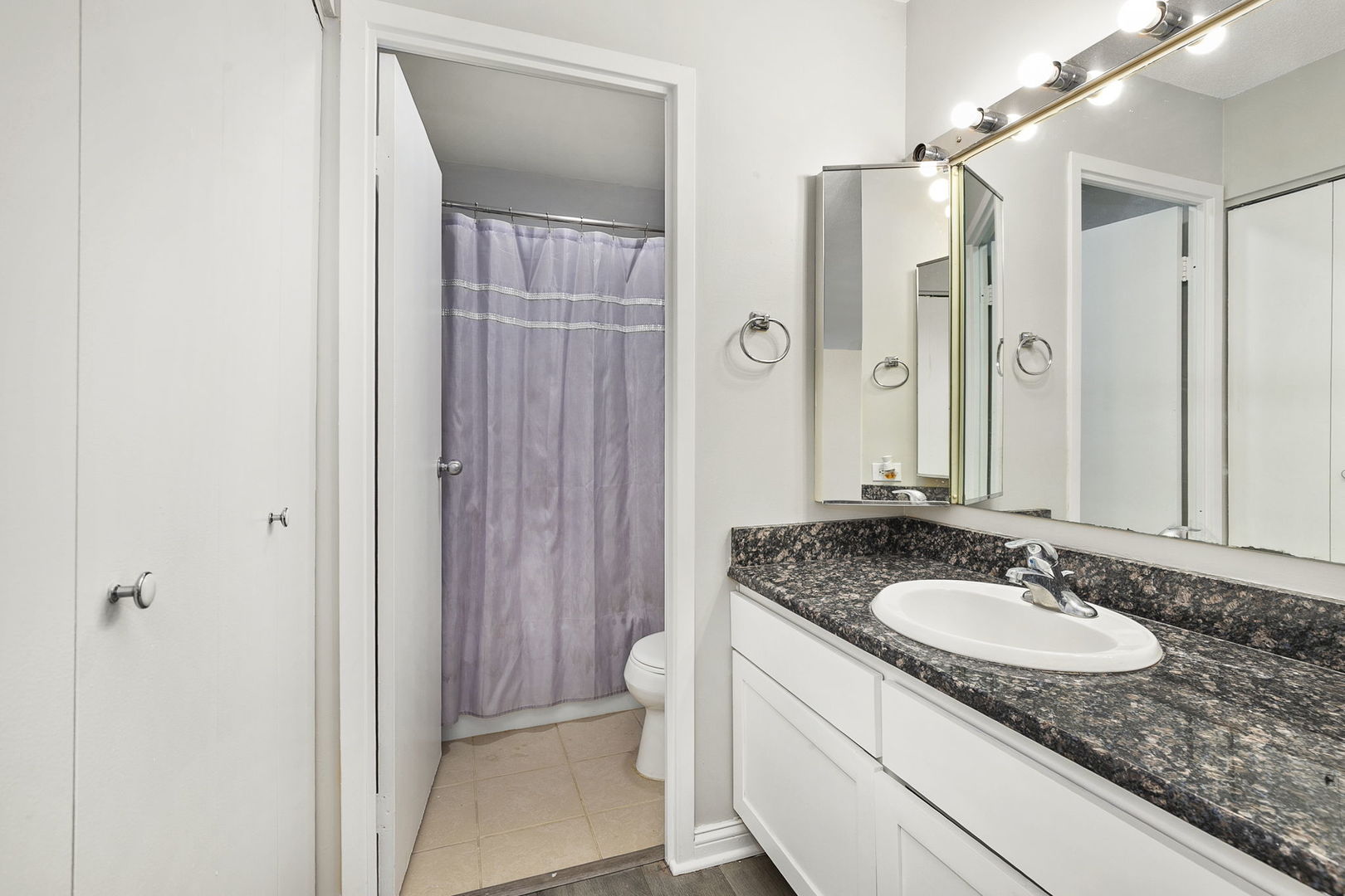 5320 North Sheridan Road, Unit 403 Chicago, IL 60640 - Photo 18 of 36 a bathroom with a granite countertop sink and a mirror