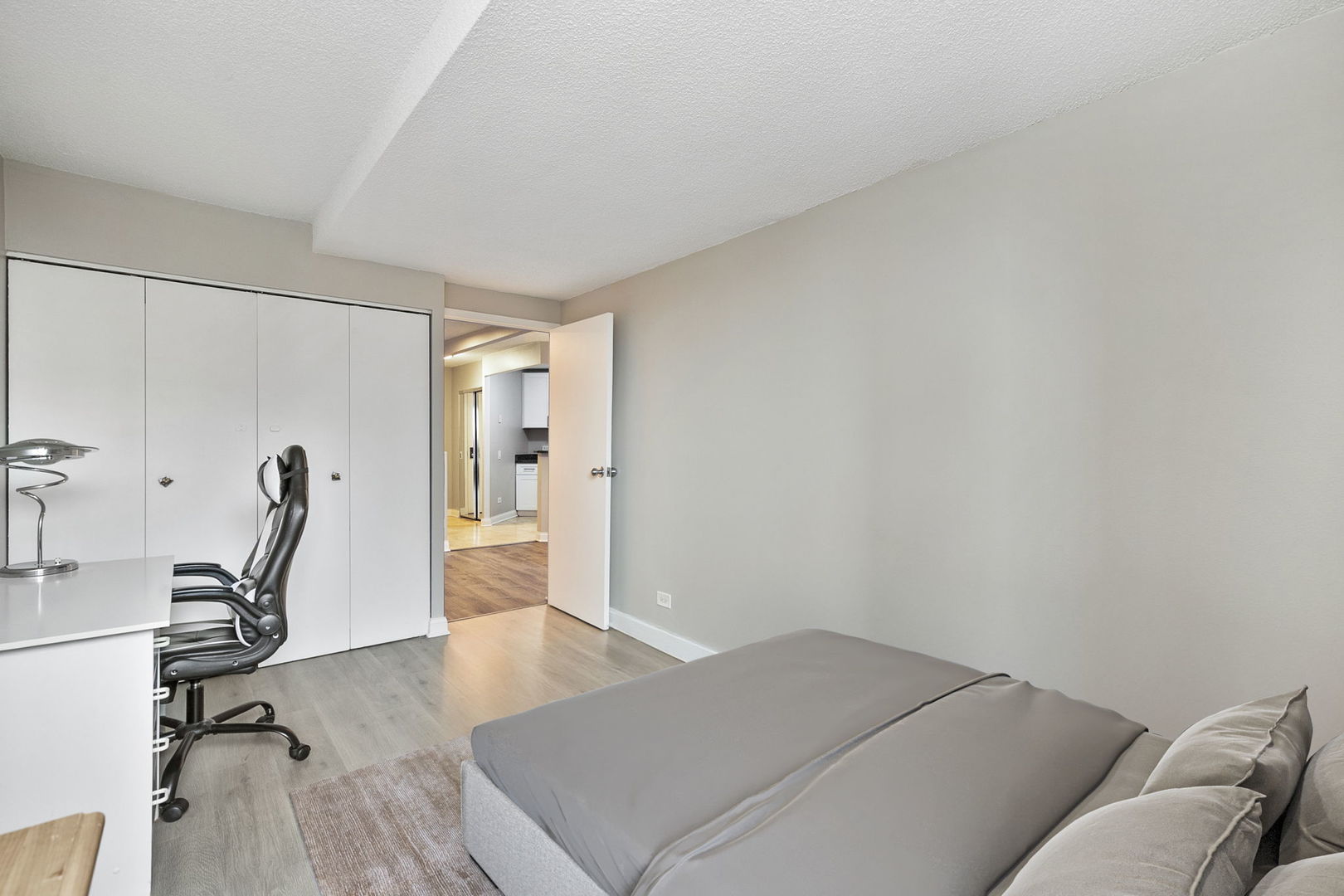 5320 North Sheridan Road, Unit 403 Chicago, IL 60640 - Photo 20 of 36 a bed room with a bed and wooden floor
