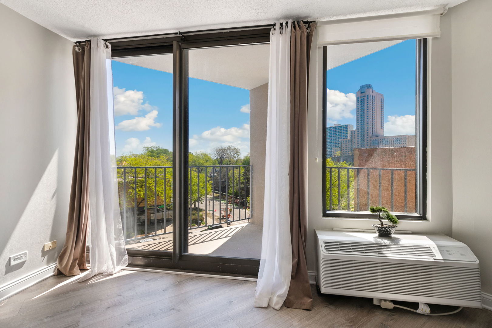 5320 North Sheridan Road, Unit 403 Chicago, IL 60640 - Photo 4 of 36 a spacious bedroom with a balcony a bed and a mirror