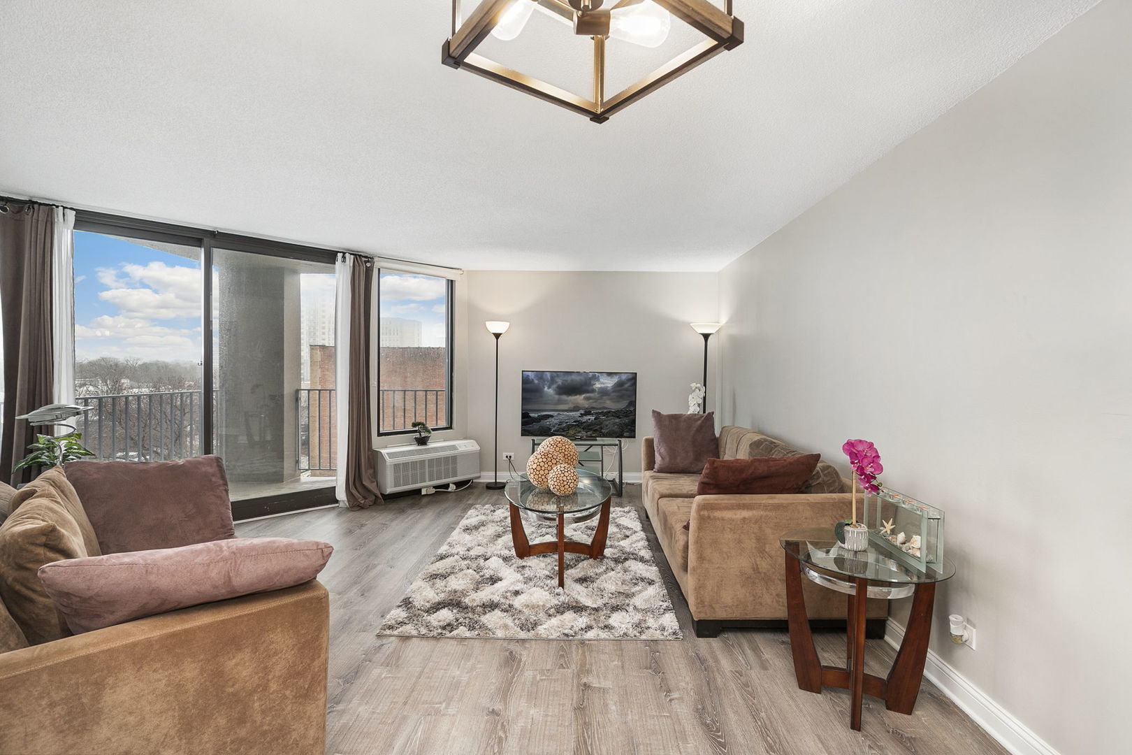 5320 North Sheridan Road, Unit 403 Chicago, IL 60640 - Photo 7 of 36 a living room with furniture and a flat screen tv
