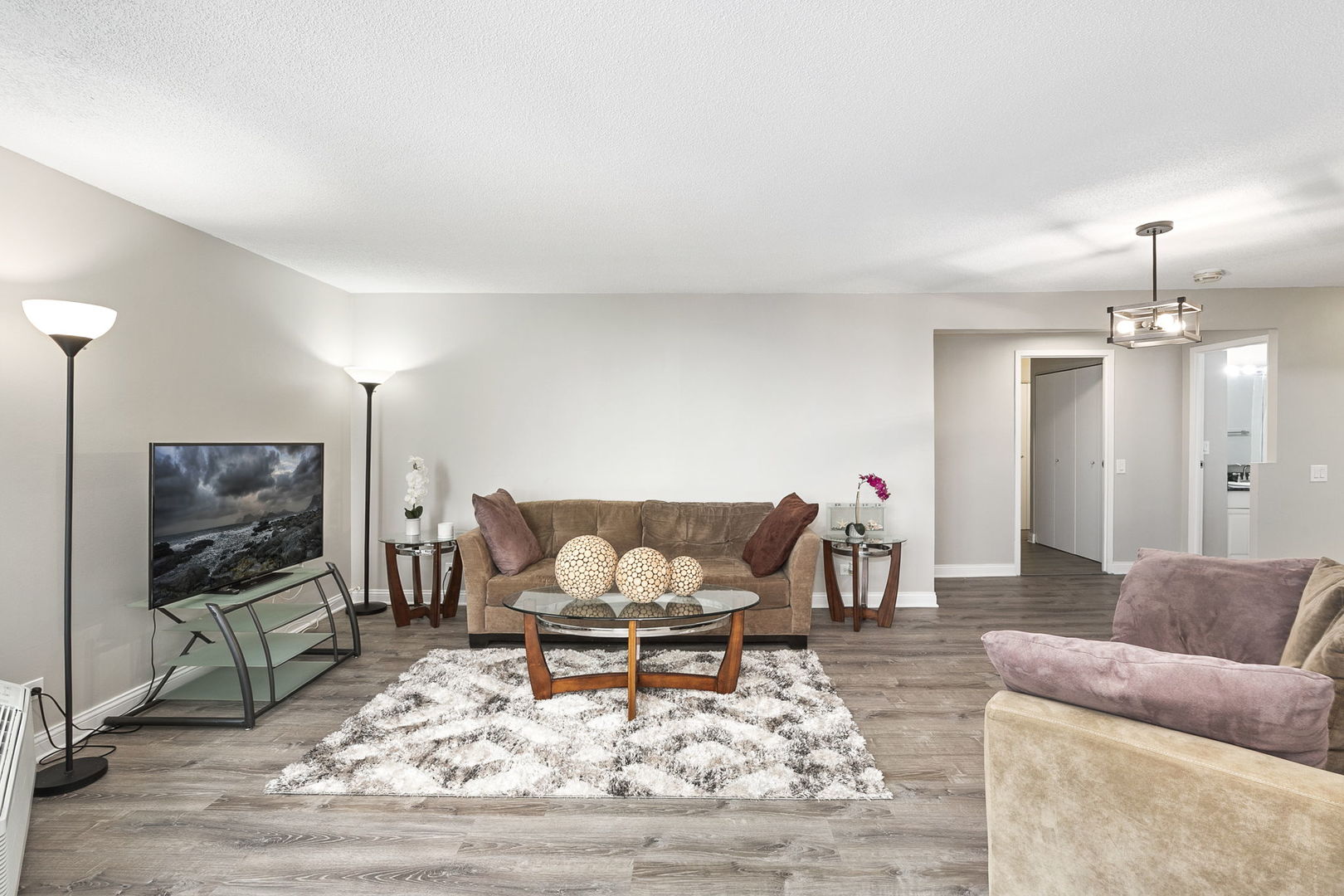 5320 North Sheridan Road, Unit 403 Chicago, IL 60640 - Photo 8 of 36 a living room with furniture and a flat screen tv
