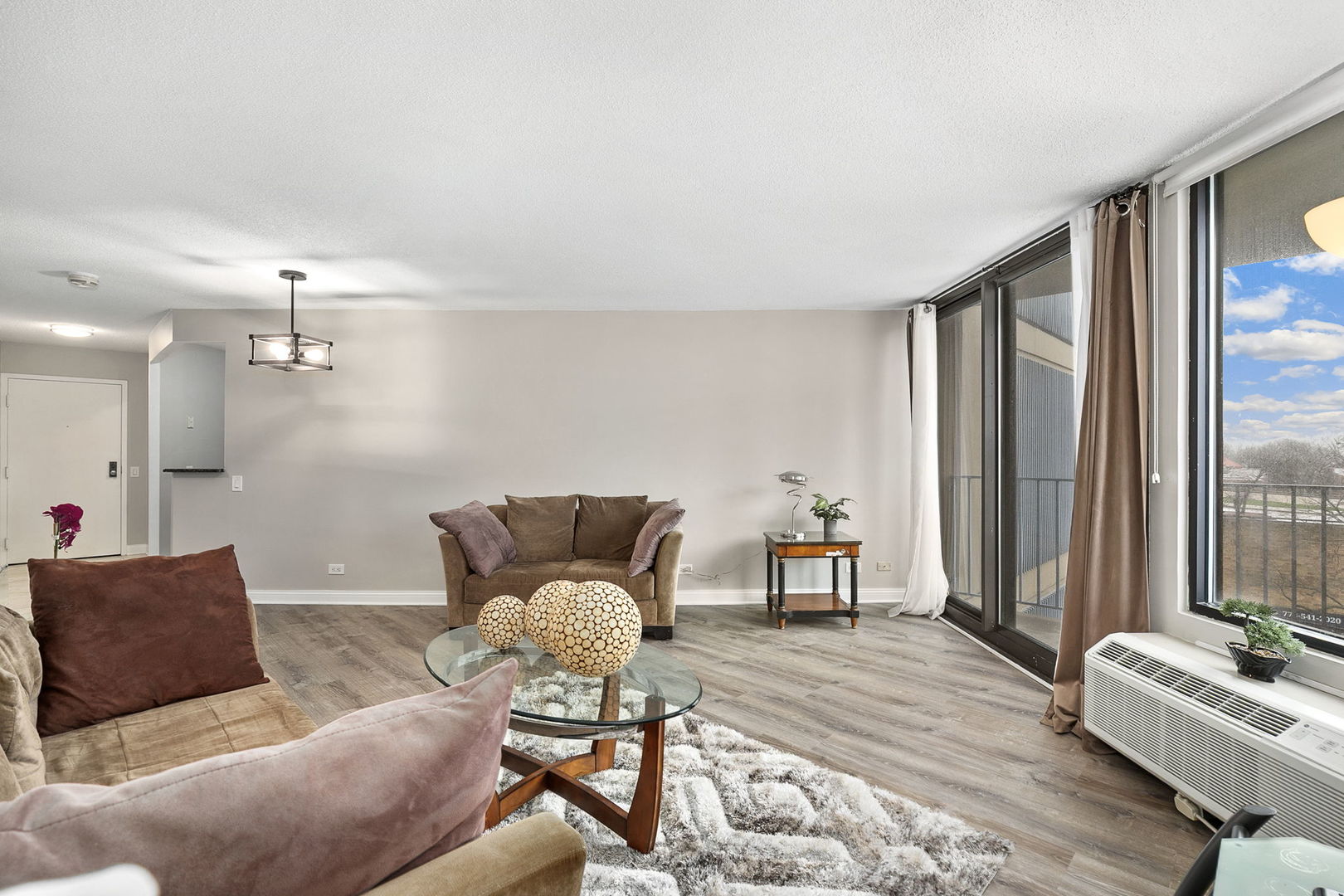 5320 North Sheridan Road, Unit 403 Chicago, IL 60640 - Photo 9 of 36 a living room with furniture and wooden floor