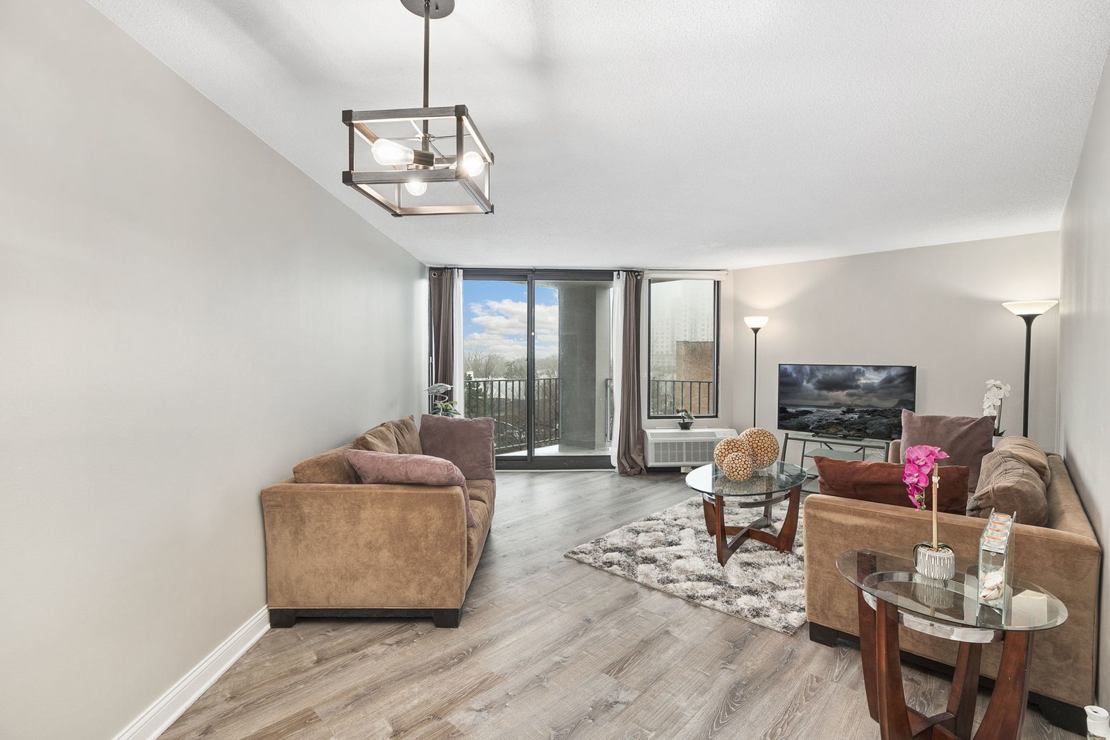 5320 North Sheridan Road, Unit 403 Chicago, IL 60640 - Photo 10 of 36 a living room with furniture and floor to ceiling windows