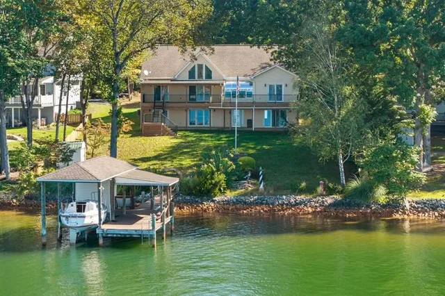 a view of a house with a yard and sitting area