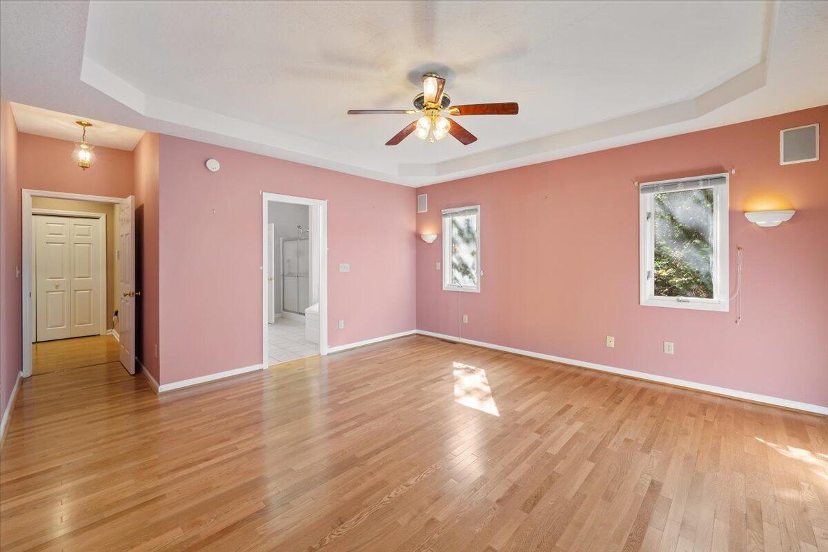 309 Tulip Tree Lane Moneta, VA 24121 - Photo 17 of 53 a view of an empty room with wooden floor and a ceiling fan