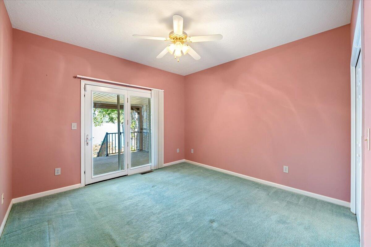 309 Tulip Tree Lane Moneta, VA 24121 - Photo 21 of 53 an empty room with a chandelier fan and windows