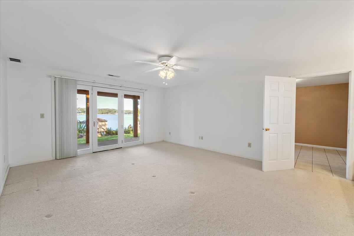 309 Tulip Tree Lane Moneta, VA 24121 - Photo 27 of 53 an empty room with windows and ceiling fan view