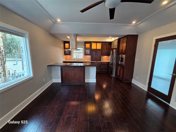 a view of a room with wooden floor and windows