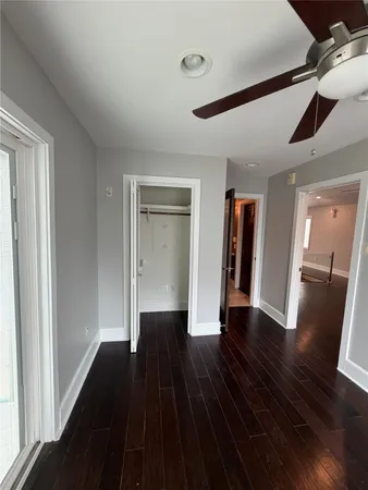 a spacious bathroom with a granite countertop sink mirror and shower