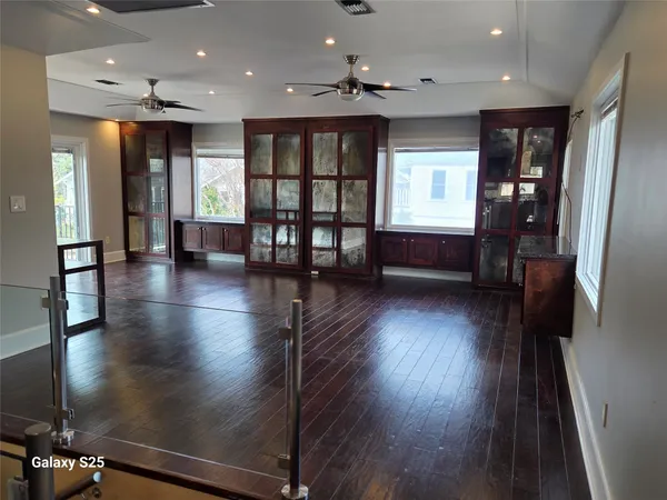 a view of lobby with furniture and wooden floor