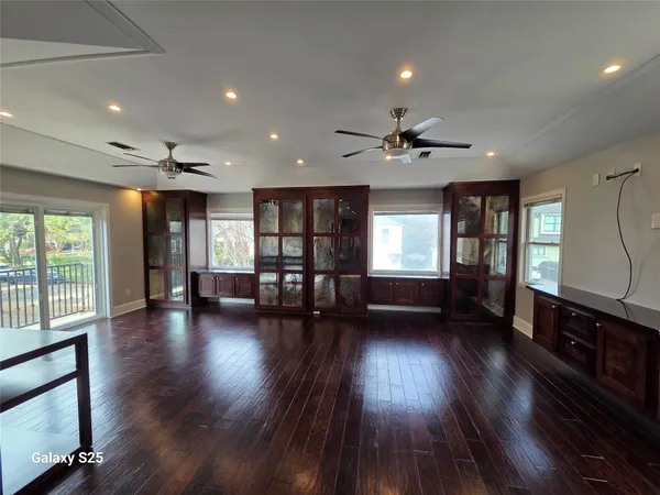 a view of a livingroom with hardwood floor and a ceiling fan