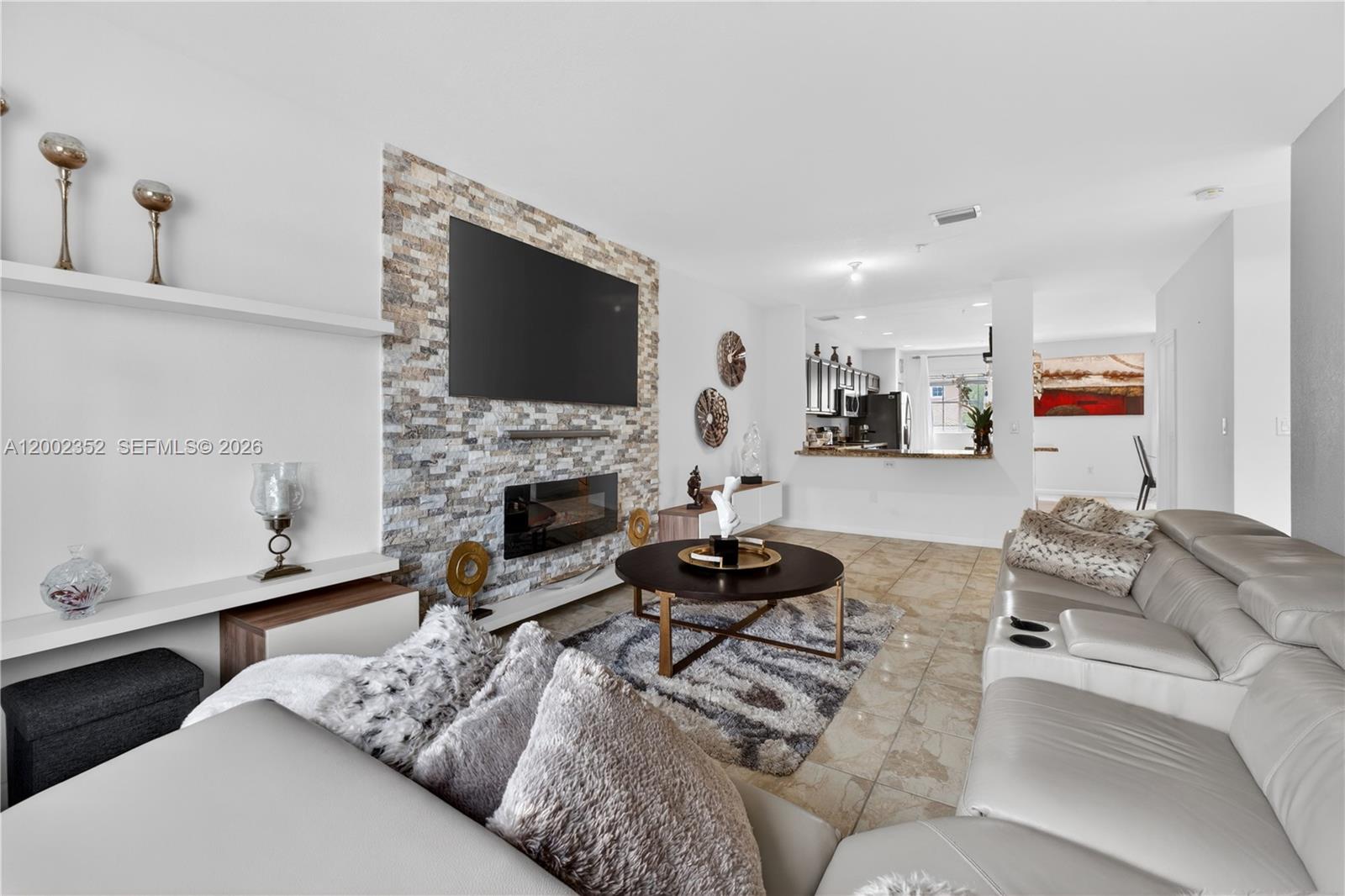 14213 Southwest 274th Street Homestead, FL 33032 - Photo 12 of 62 a living room with furniture a flat screen tv and a fireplace