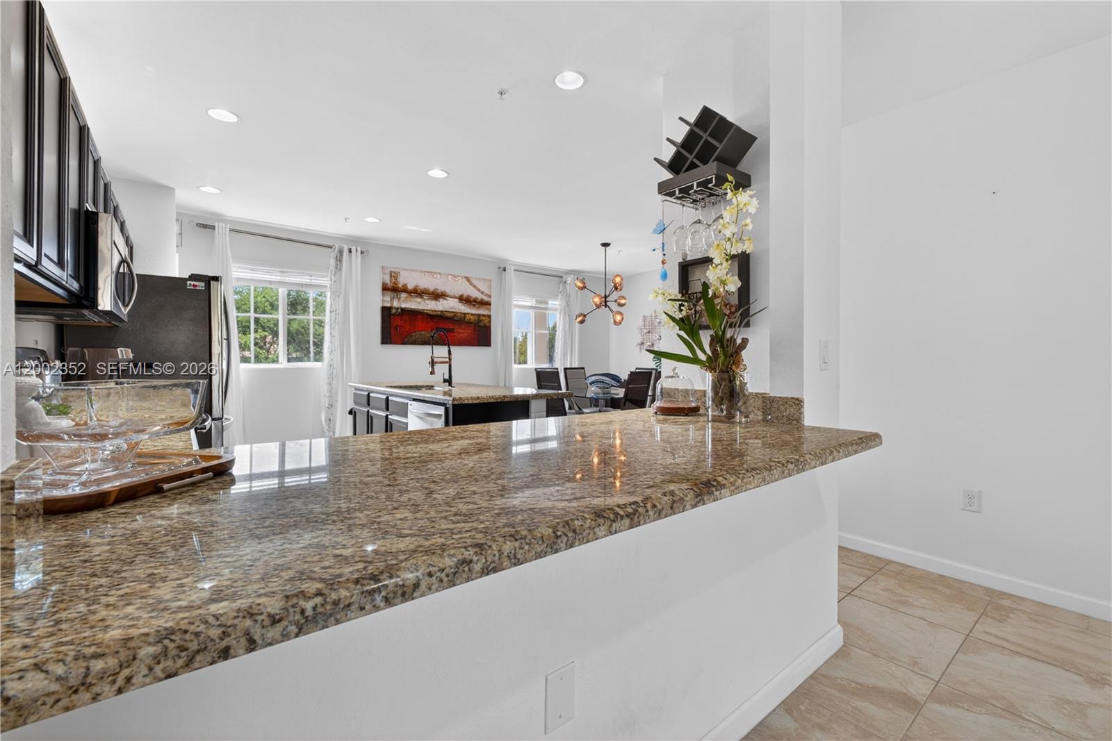 14213 Southwest 274th Street Homestead, FL 33032 - Photo 15 of 62 a kitchen with stainless steel appliances granite countertop a sink a stove and a wooden floors