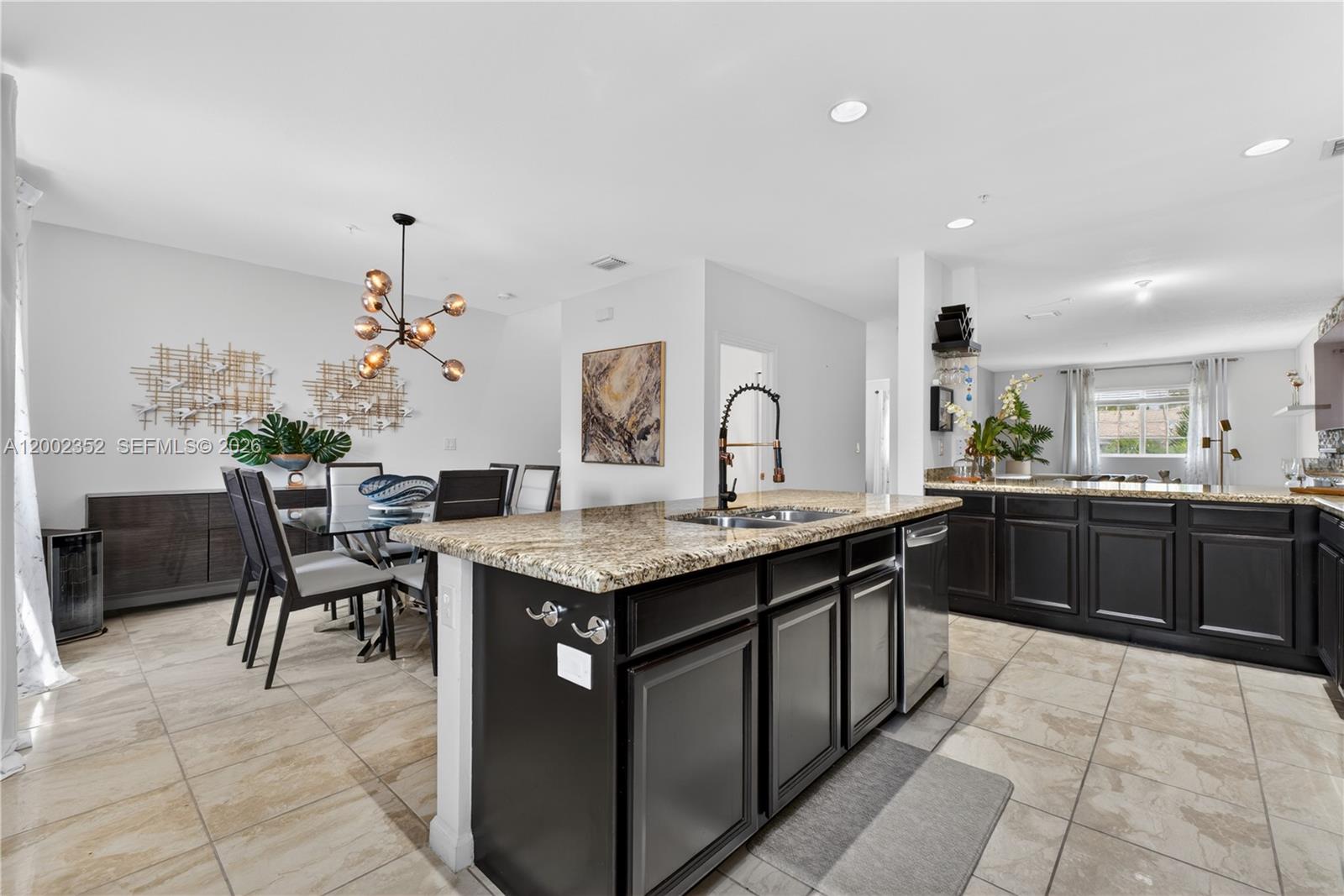 14213 Southwest 274th Street Homestead, FL 33032 - Photo 19 of 62 a kitchen with a stove a table and chairs in it
