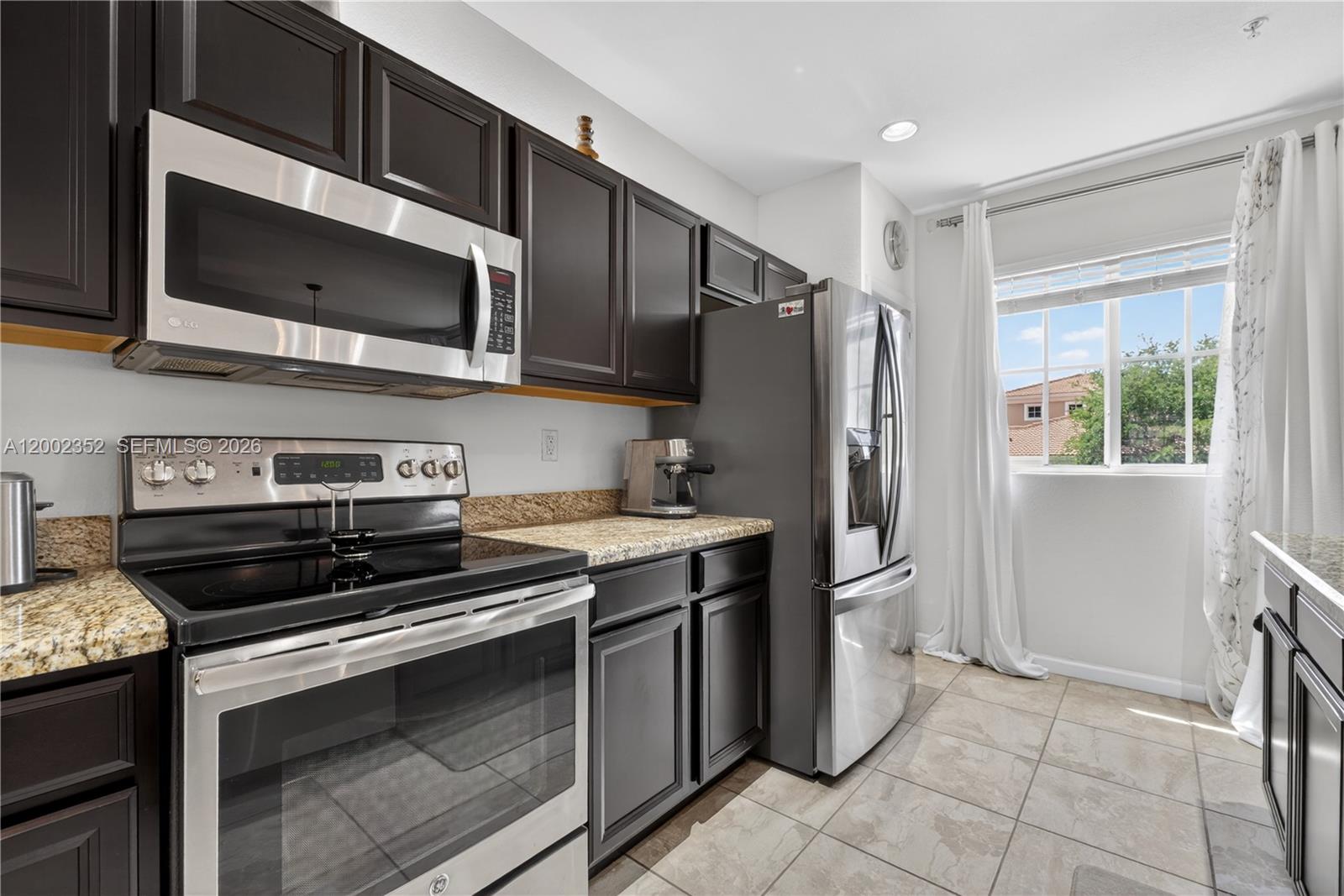 14213 Southwest 274th Street Homestead, FL 33032 - Photo 20 of 62 a kitchen with stainless steel appliances and cabinets