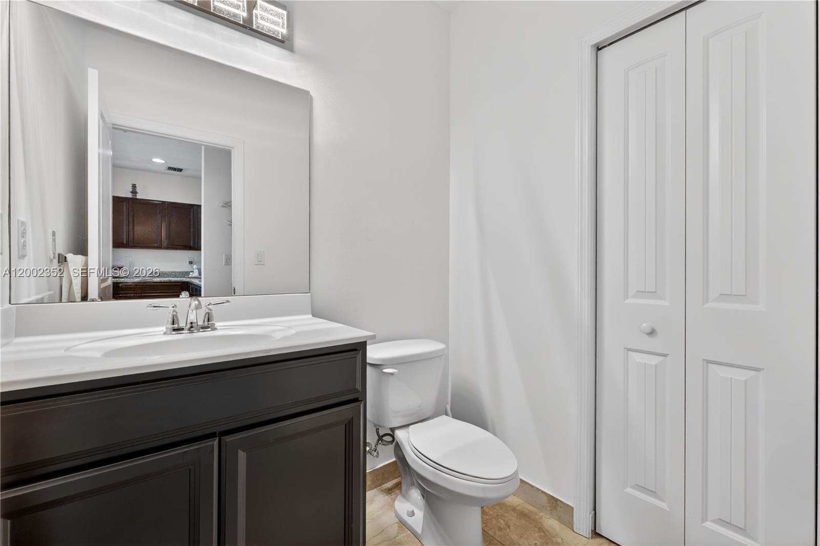 14213 Southwest 274th Street Homestead, FL 33032 - Photo 23 of 62 a bathroom with a granite countertop sink toilet and mirror