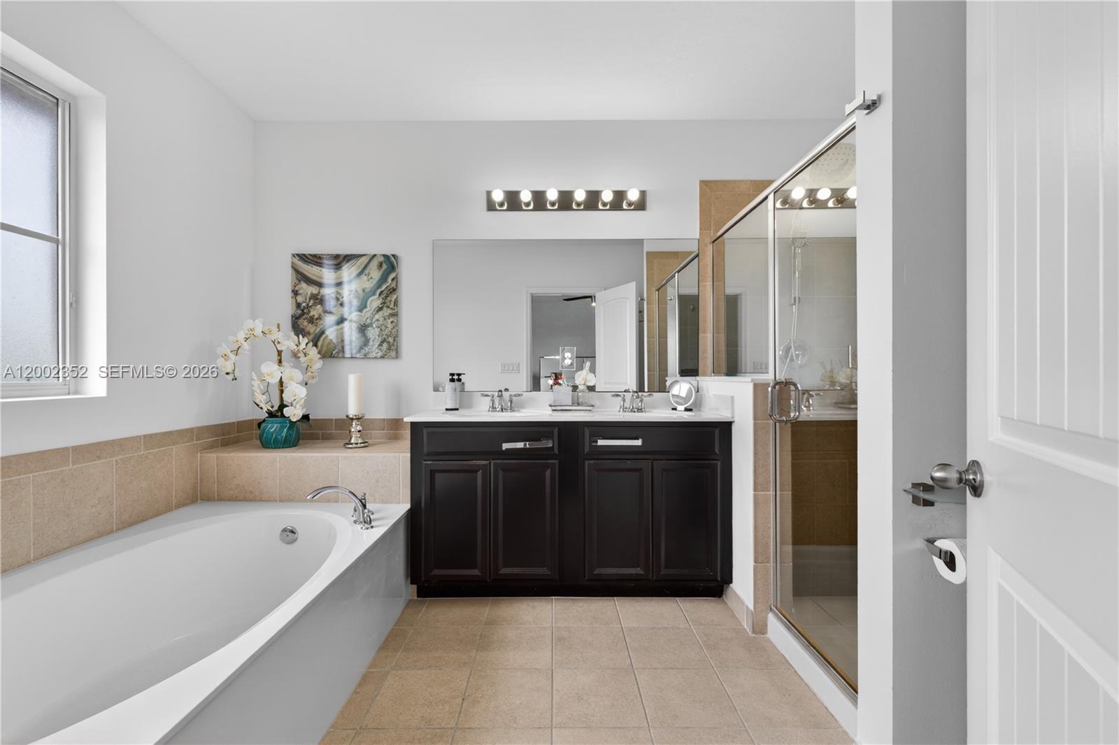 14213 Southwest 274th Street Homestead, FL 33032 - Photo 30 of 62 a bathroom with a bathtub a sink and a mirror