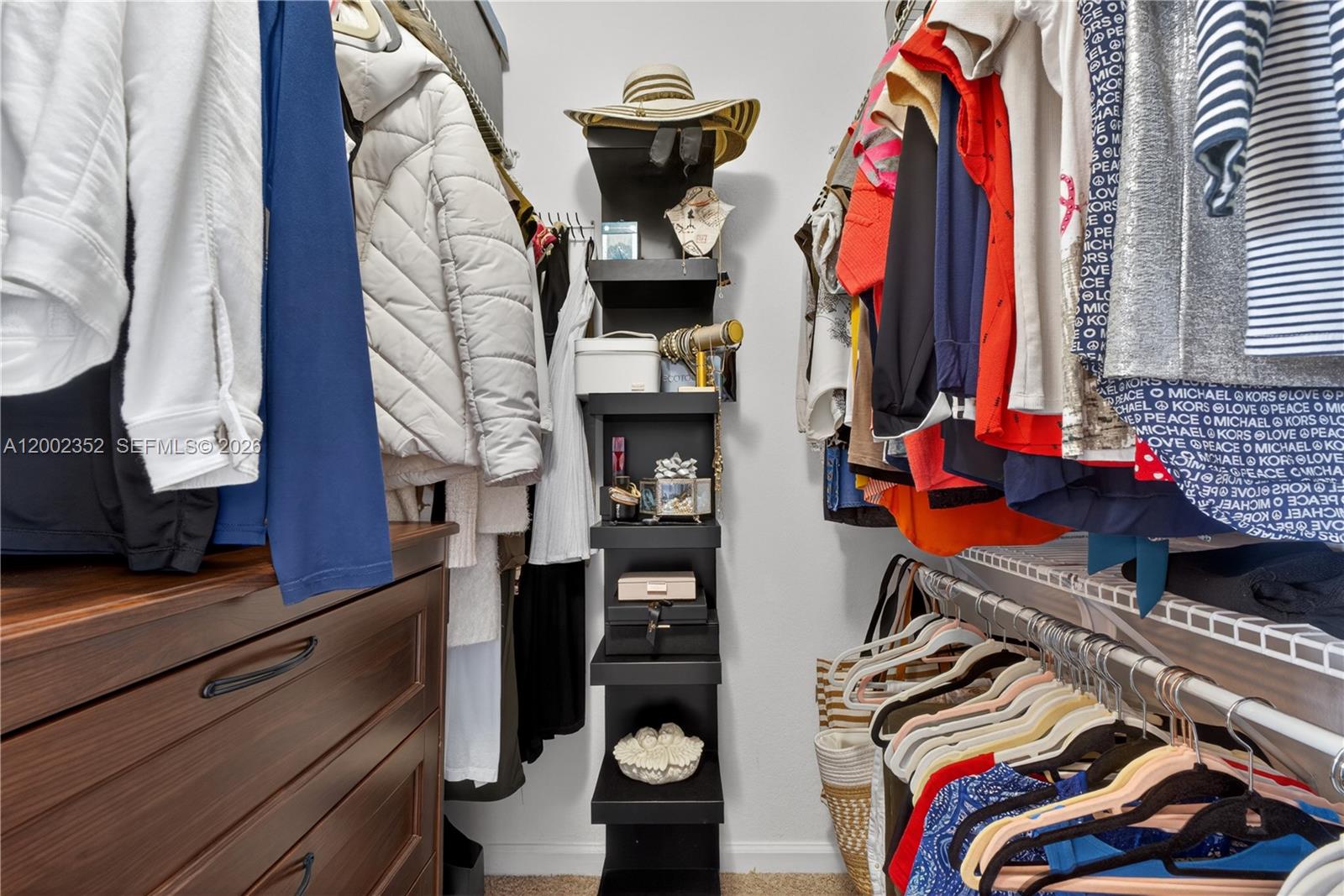 14213 Southwest 274th Street Homestead, FL 33032 - Photo 33 of 62 a view of walk in closet with clothes and shoes