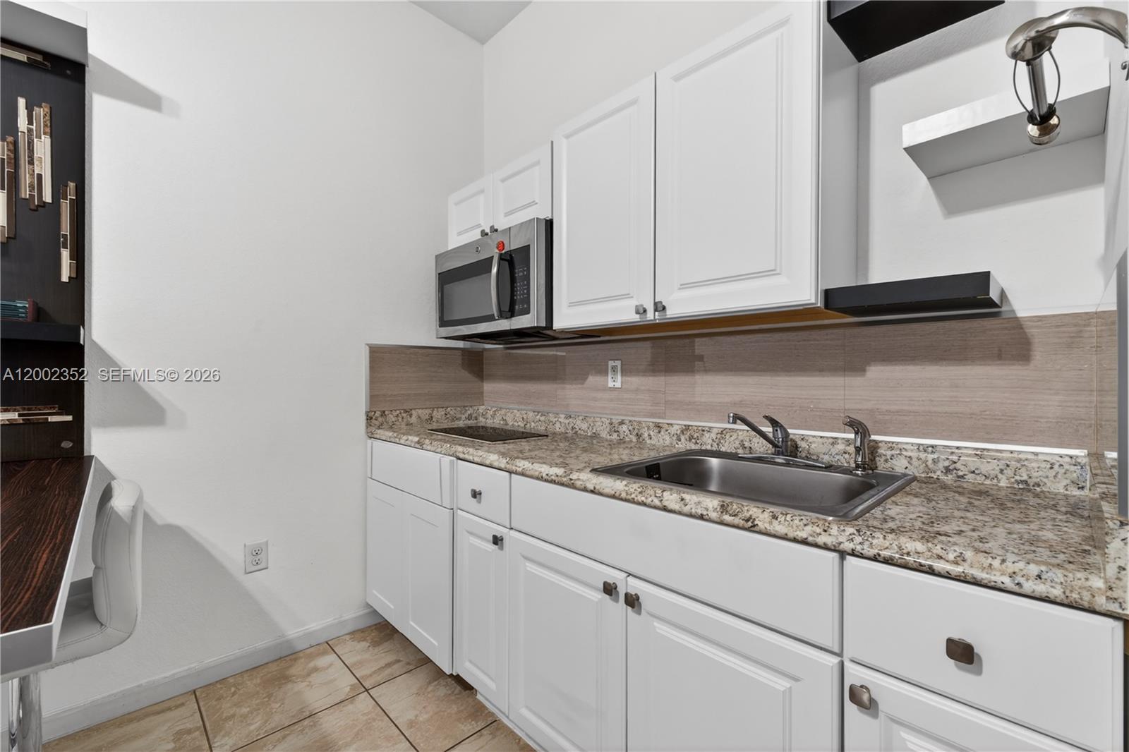 14213 Southwest 274th Street Homestead, FL 33032 - Photo 44 of 62 a kitchen with granite countertop white cabinets and a sink