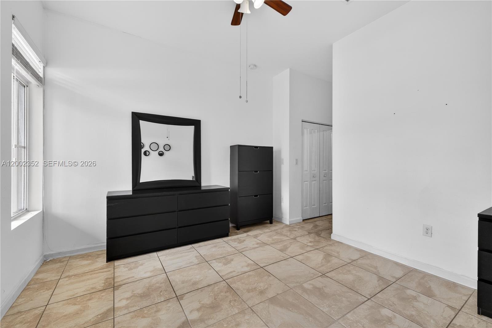 14213 Southwest 274th Street Homestead, FL 33032 - Photo 49 of 62 a spacious bedroom with a bed and a cabinets