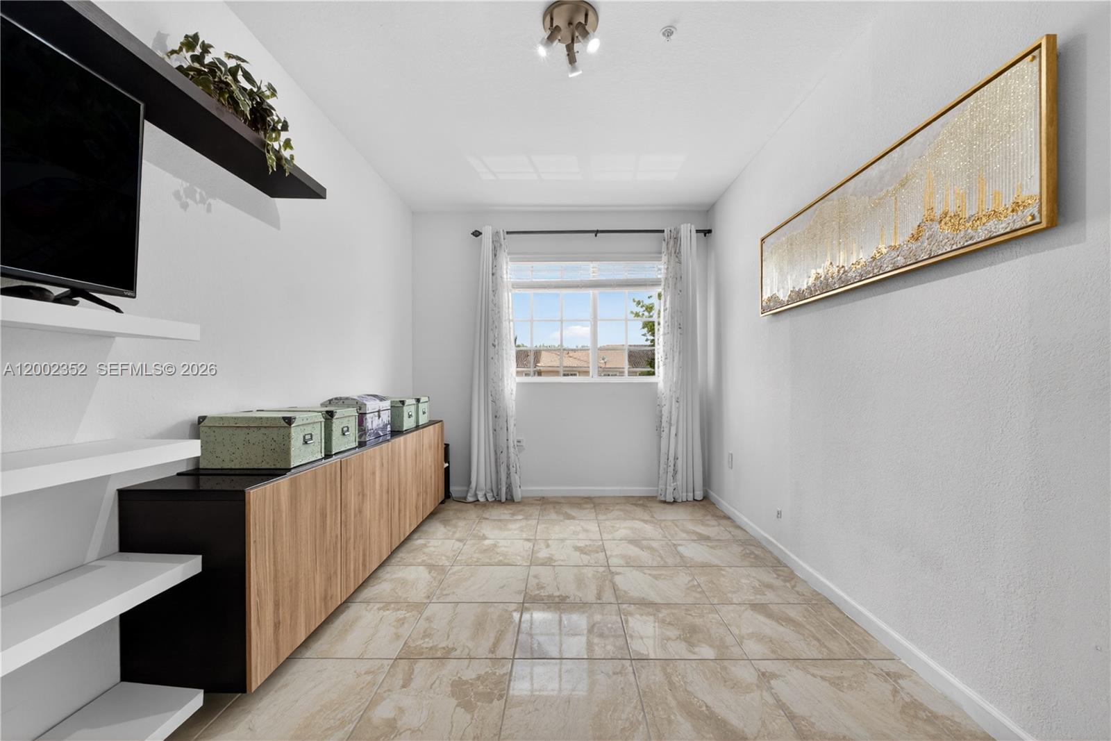14213 Southwest 274th Street Homestead, FL 33032 - Photo 9 of 62 a view of a hallway with workspace and flat screen tv