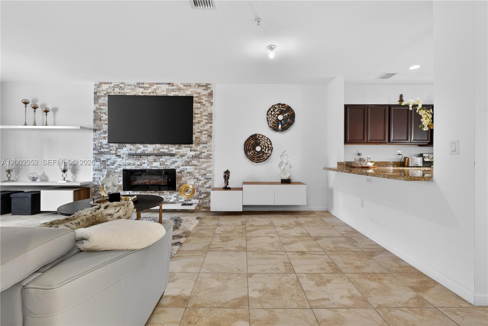 14213 Southwest 274th Street Homestead, FL 33032 - Photo 10 of 62 a living room with furniture a flat screen tv and a fireplace