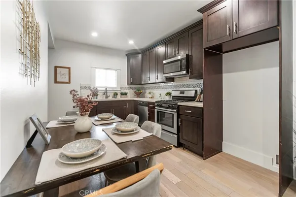 a kitchen with stainless steel appliances kitchen island granite countertop a sink and cabinets