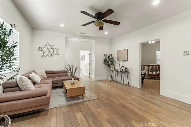 a living room with furniture and a wooden floor