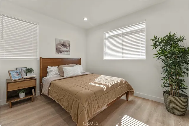 a large bed sitting in a bedroom next to a window and a chair
