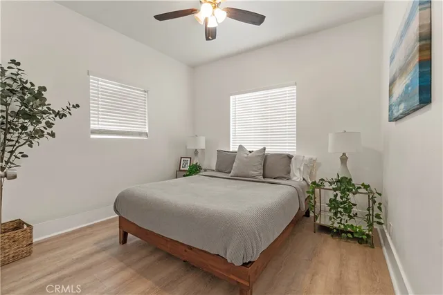 a bedroom with a bed chandelier and a window